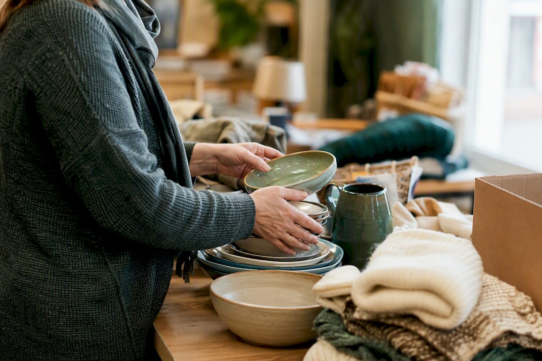 Hands sorting household items for donation