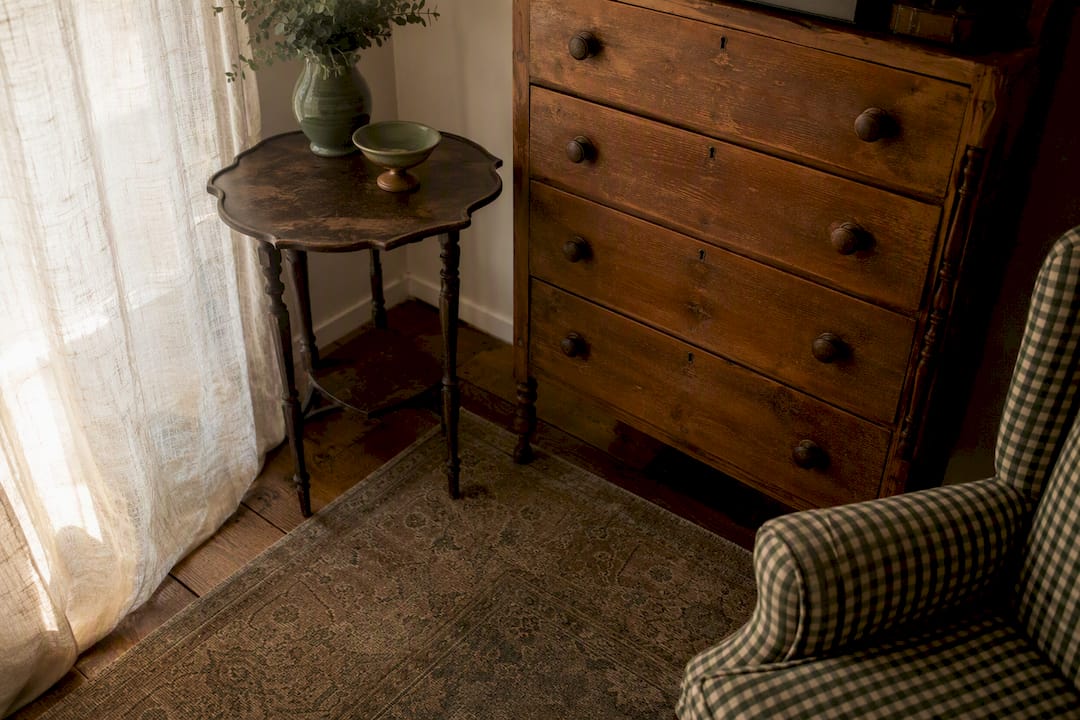 Vintage wooden dresser and side table in room