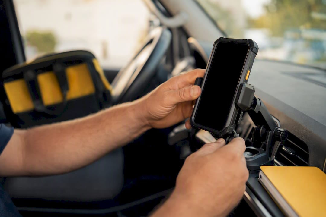 Technician setting up mobile device in service van