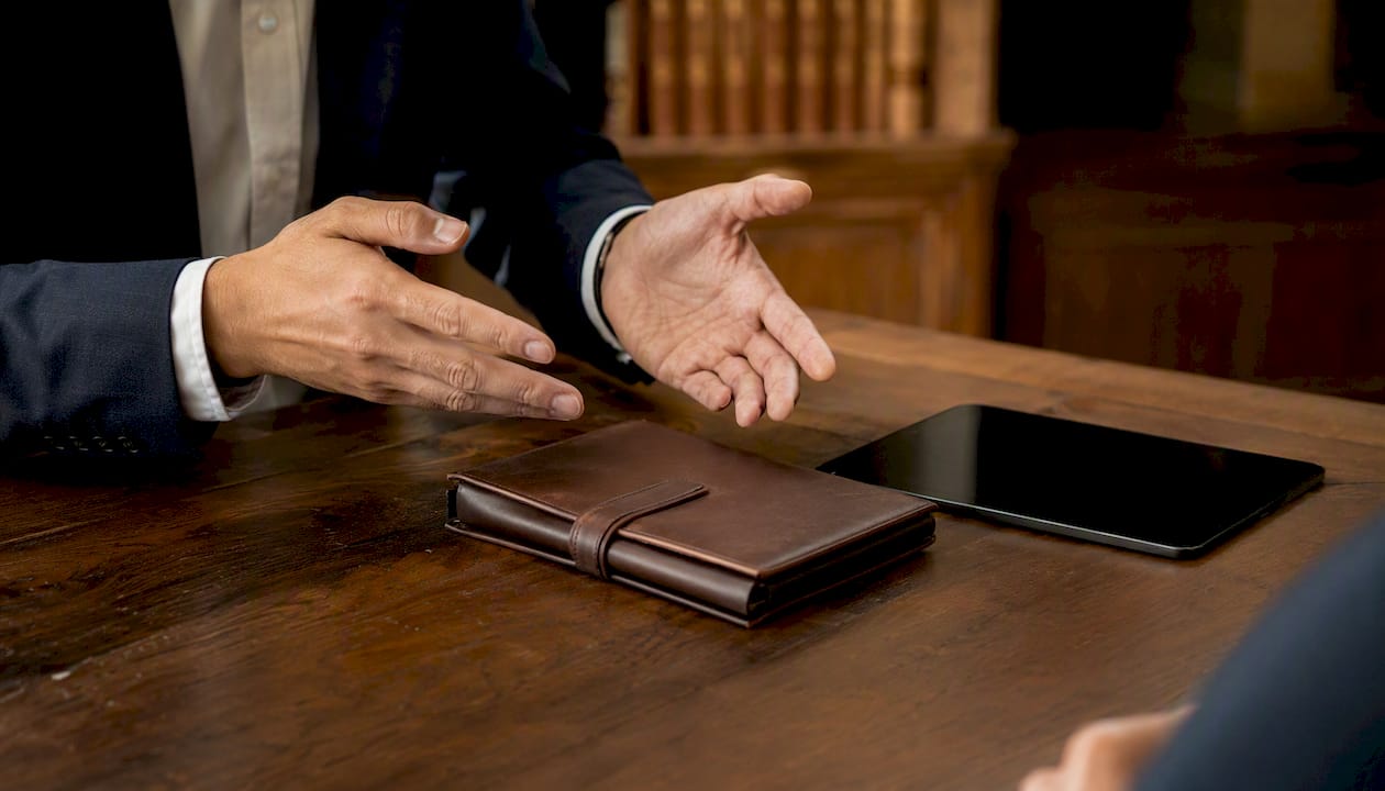 Financial adviser hands pointing at tablet in office