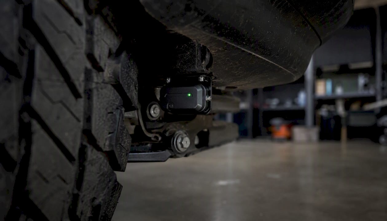 Close-up of vehicle tow-away sensor mounted under wheel arch