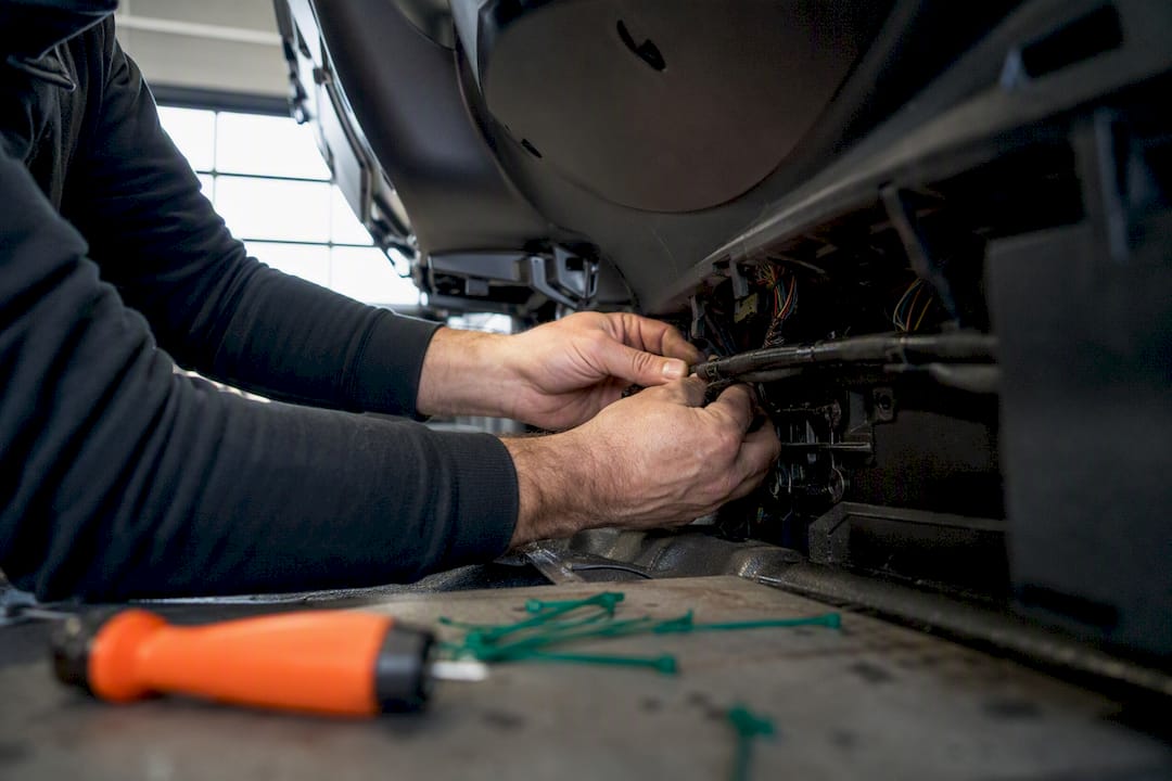 Installer routing concealed wiring in vehicle panel