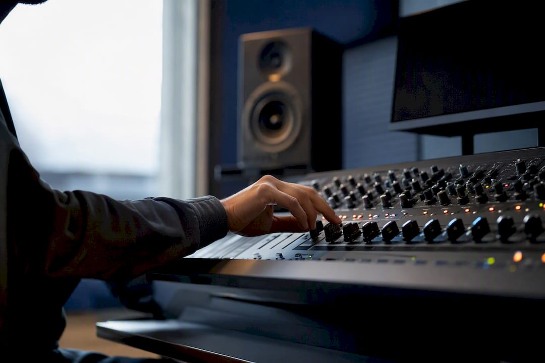 Hand adjusting audio mixer for voice coaching