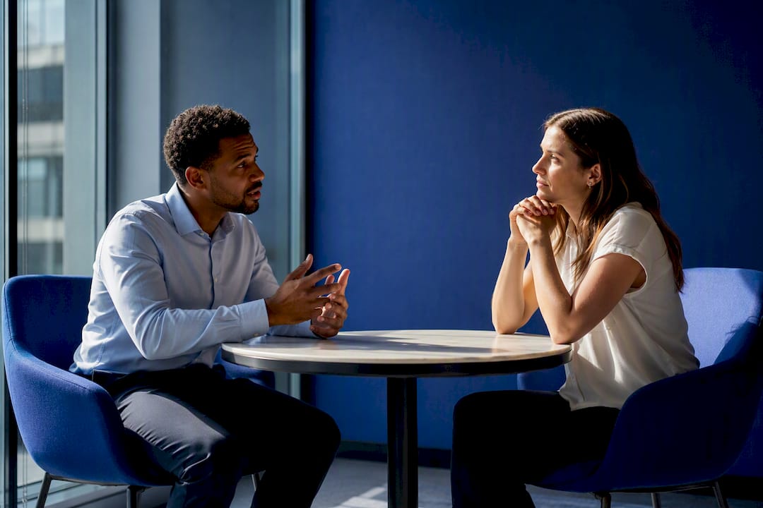 Manager coaching representative in meeting room