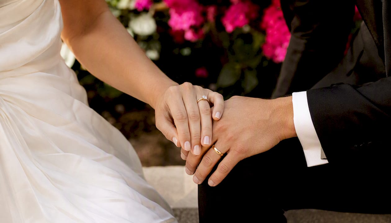 Bride and groom hands with warm editorial color grade