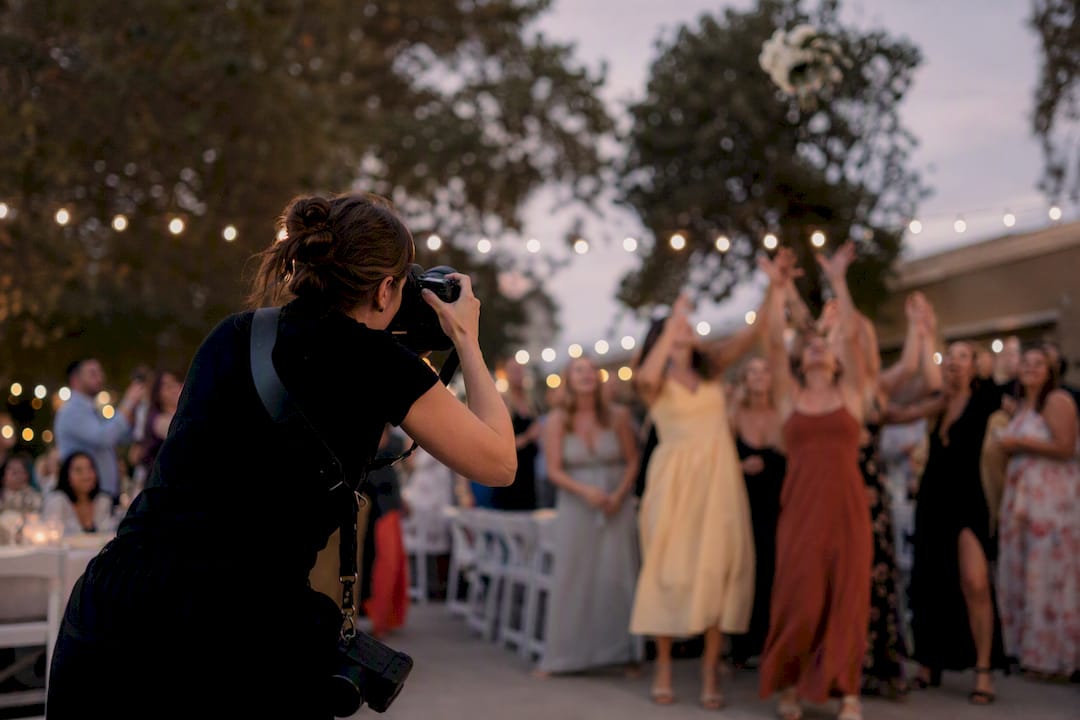 Photographer capturing fast moving wedding moments digitally