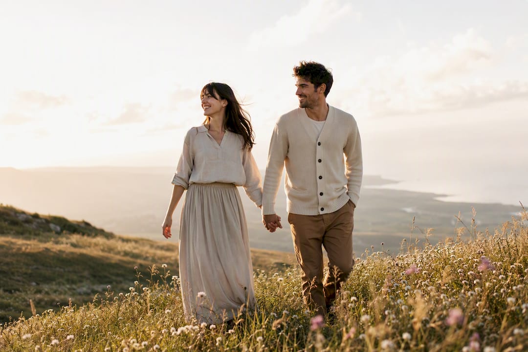 Couple wearing earth tone outfits in woodland