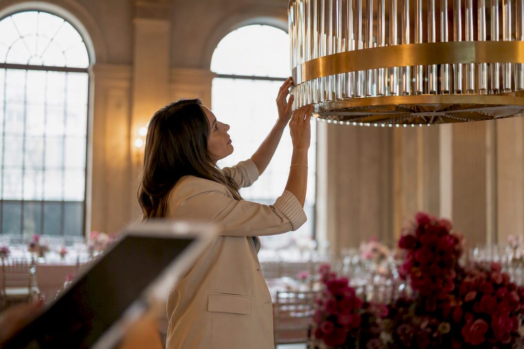 Hands adjusting wedding venue lighting during walkthrough