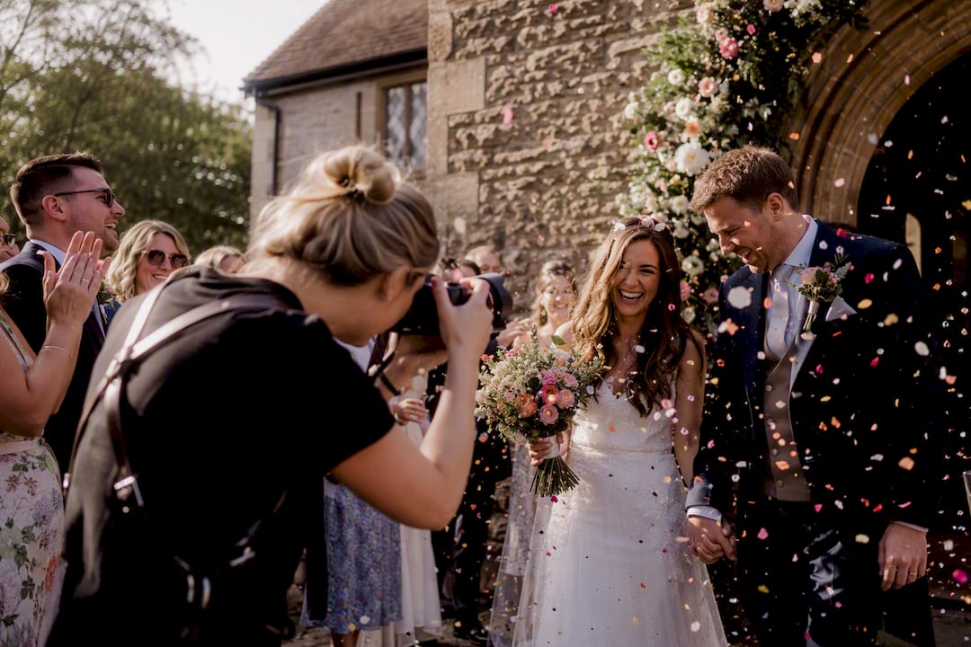Photographer capturing confetti throw at wedding ceremony