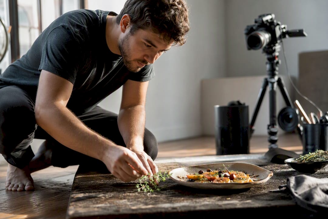 Photographer adjusting lighting for menu dish