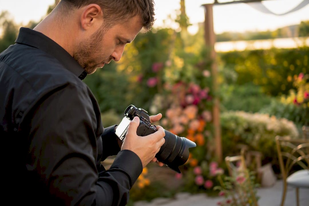 Event photographer adjusting camera settings
