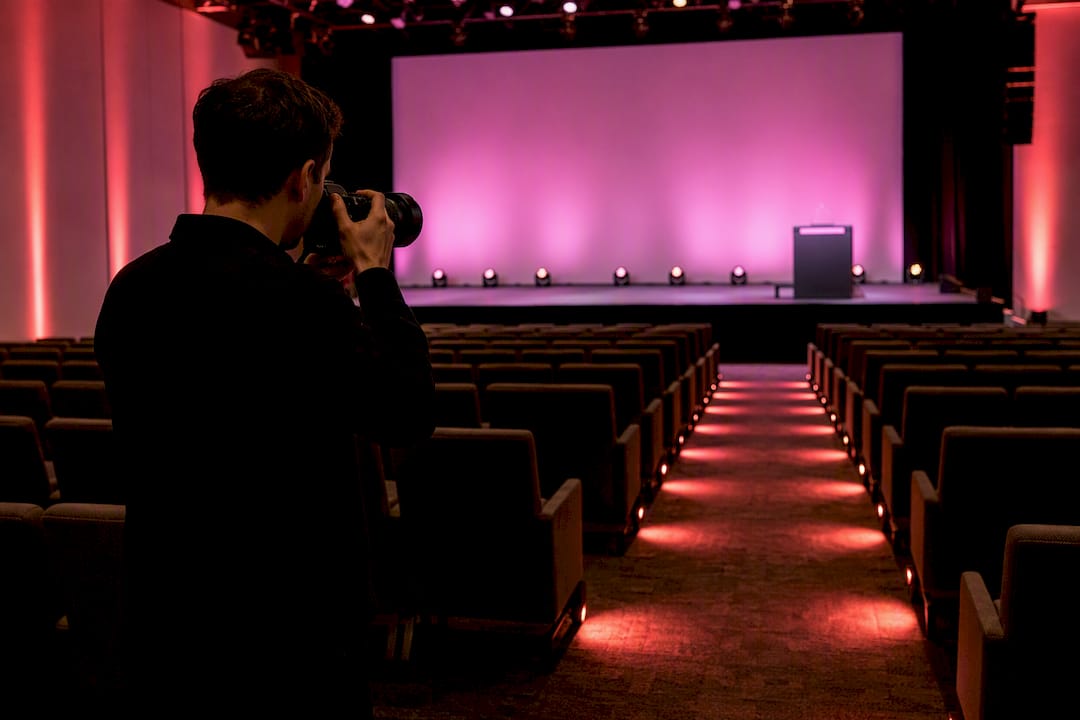 Photographer framing a prepared conference stage