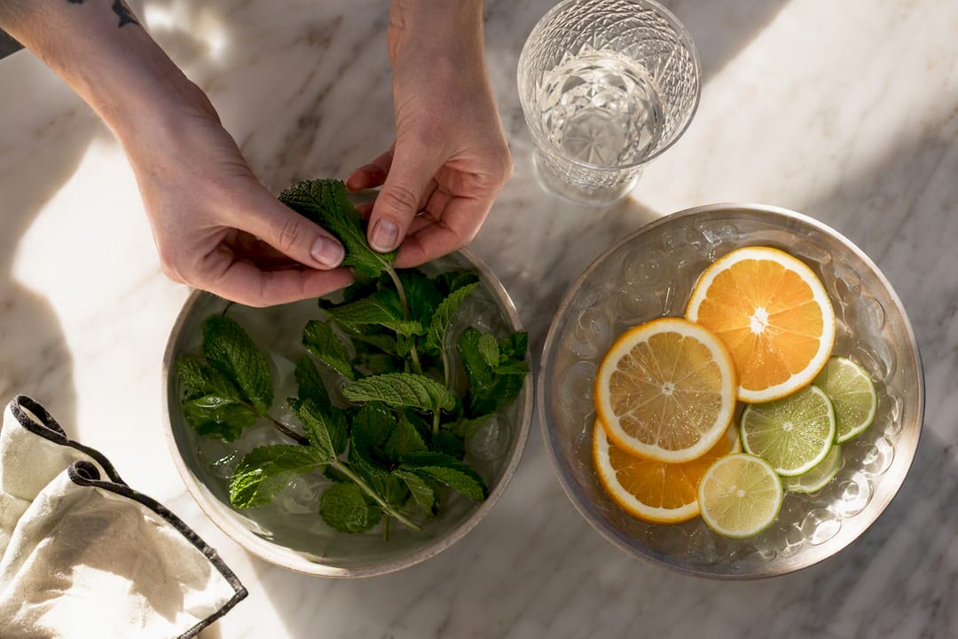 Fresh cocktail garnishes held in iced water