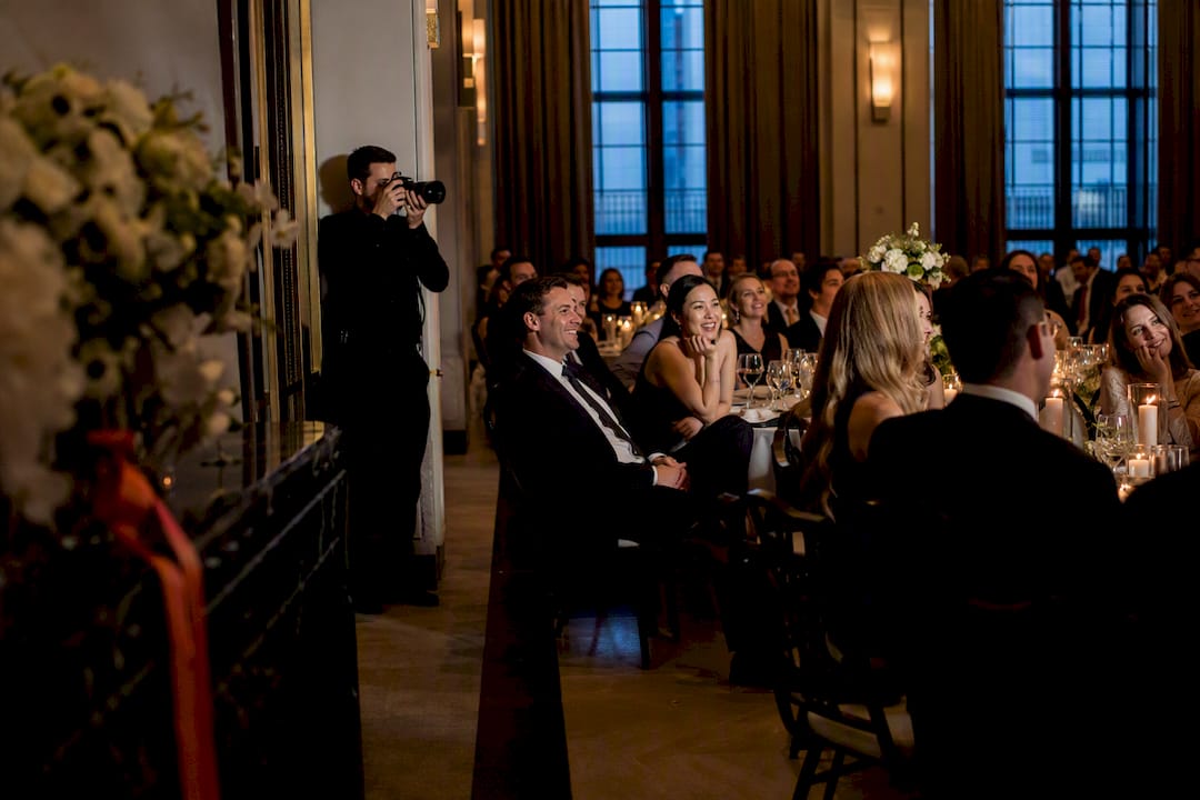 Photographer capturing candid wedding guest reactions