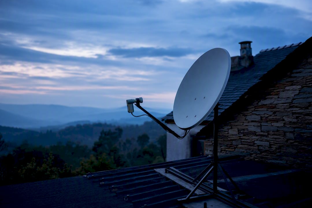 Satellite dish mounted on rural home roof