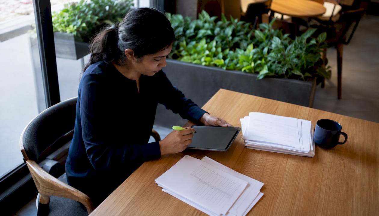 Woman reviewing invoices in home office