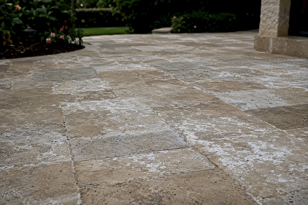 Close-up of white mineral efflorescence on travertine stone
