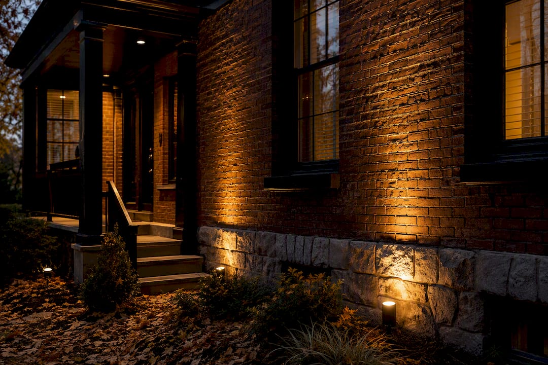 Warm LED lights highlighting brick facade at dusk