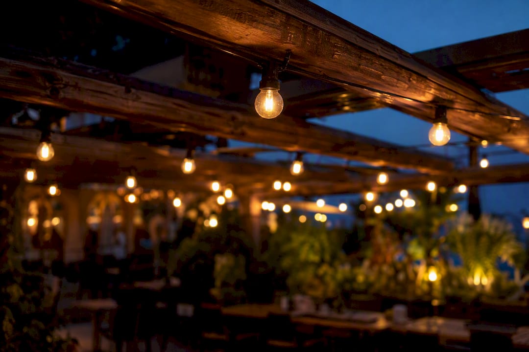 LED string lights on steel cables at patio ceiling