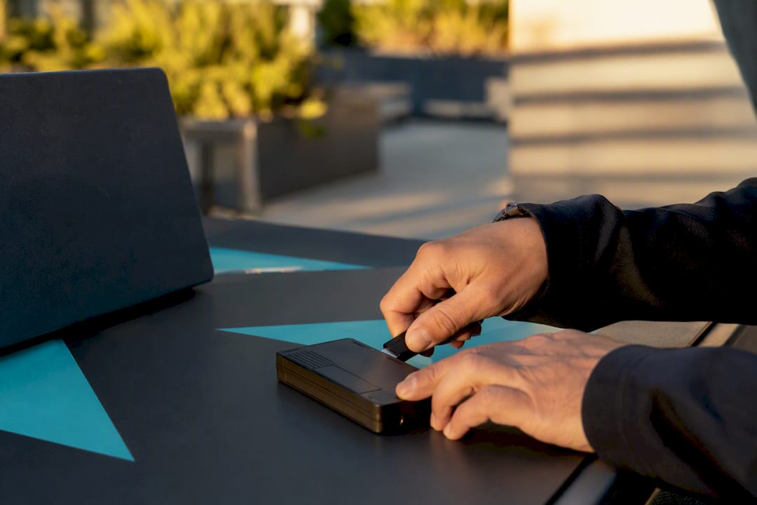 Hands connecting USB security token to data device