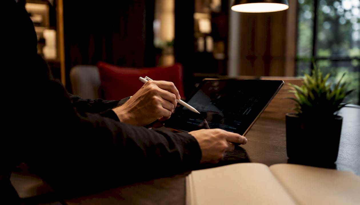 Hands clipping video segment on tablet