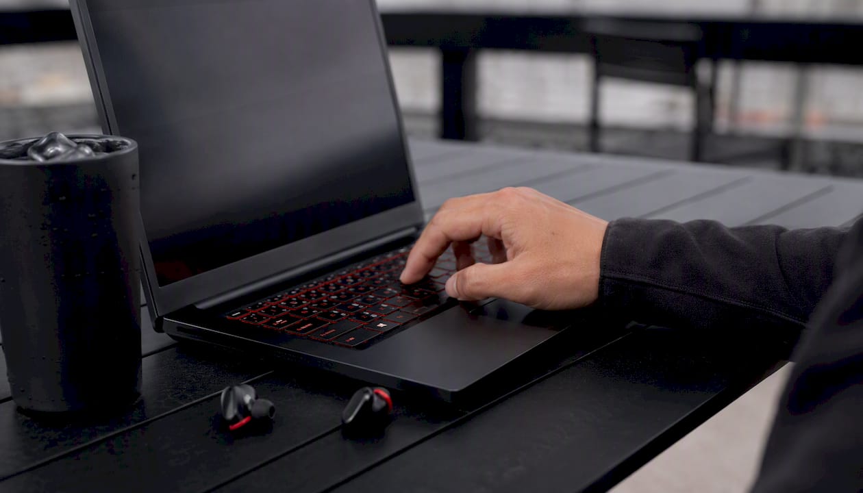 Hand navigating YouTube video timestamps on laptop