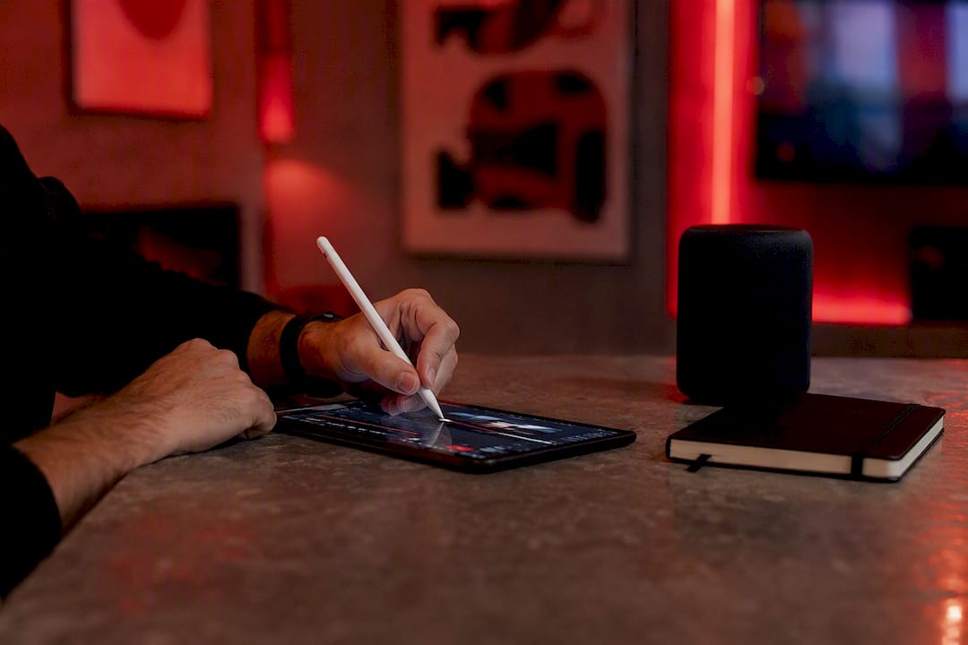 Hands marking video timeline with stylus