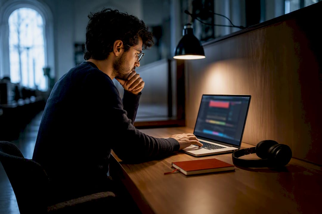 Researcher verifying video timestamps in media lab