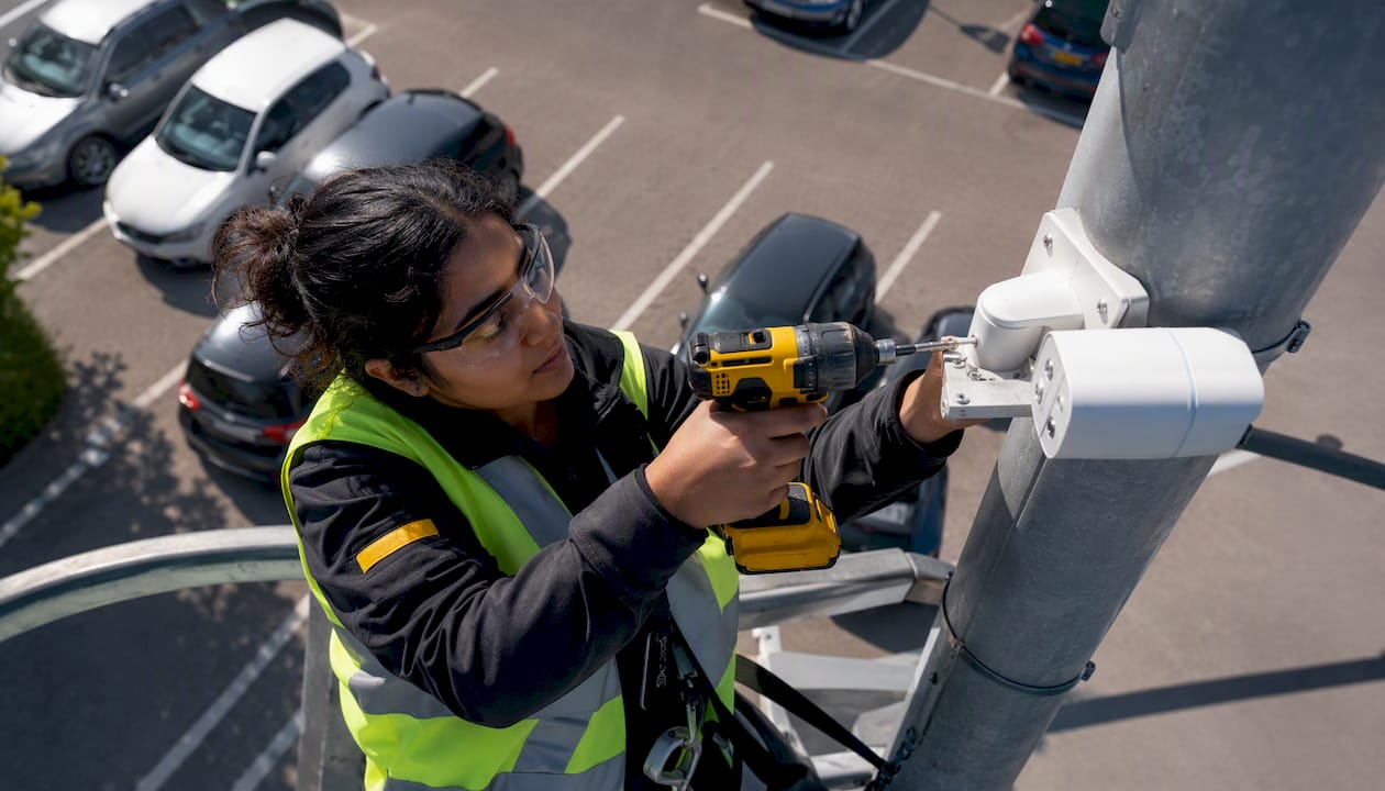 Technician installing ANPR camera on pole