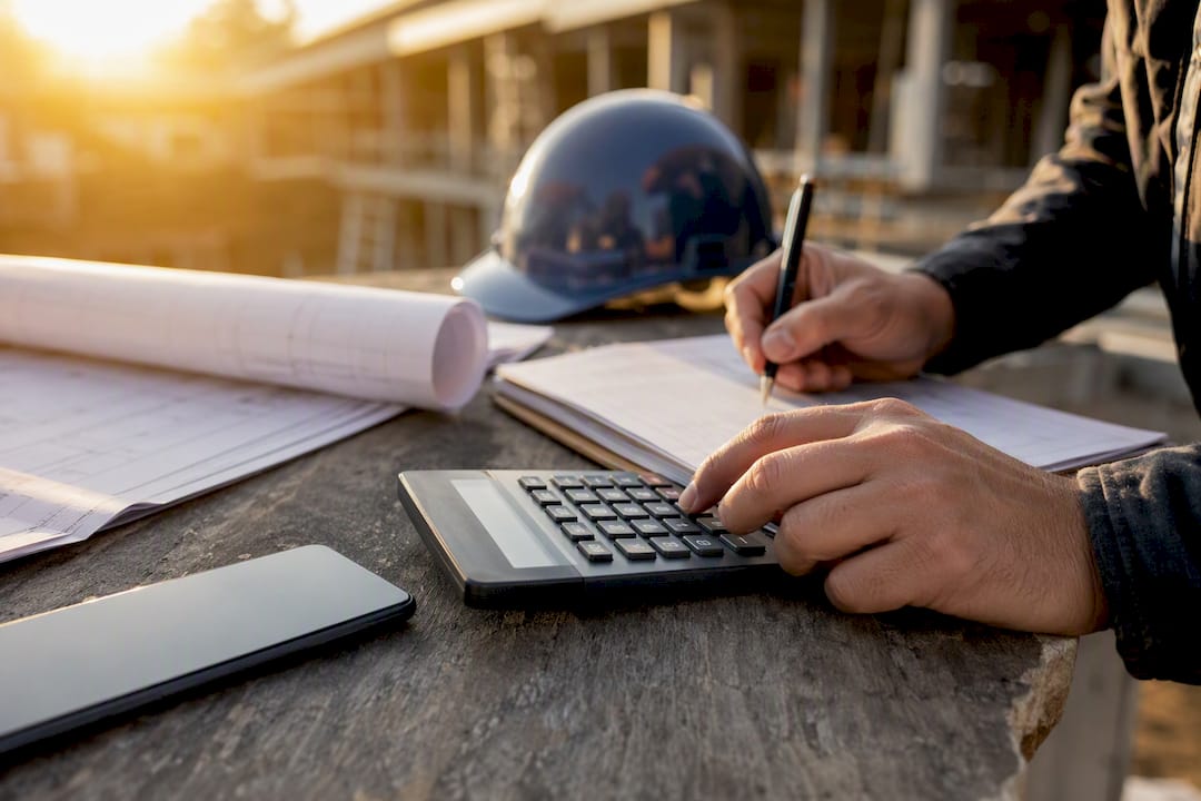Hands calculating construction budget