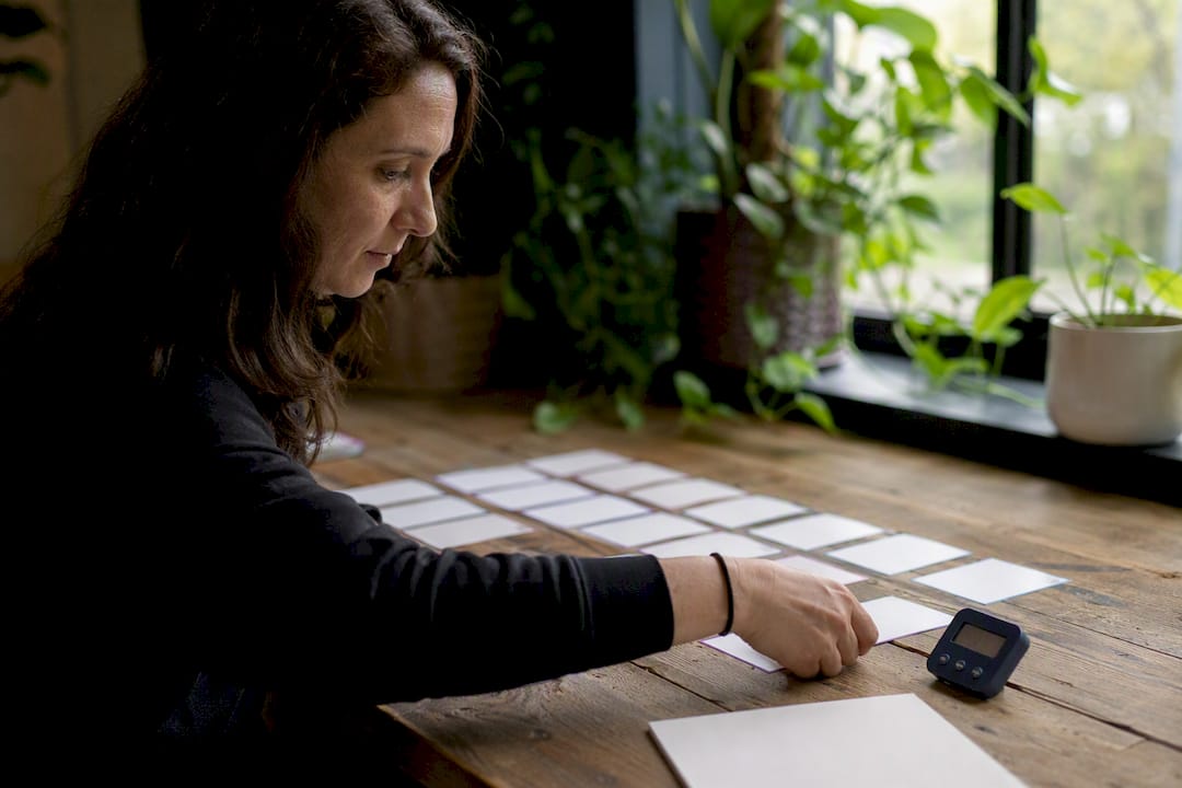 Hands manipulating decision practice cards on a table