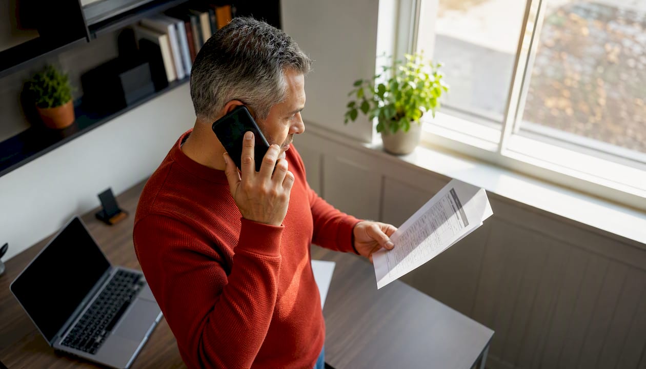Man verifying caregiver license on phone