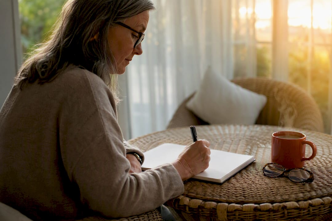 Caregiver writing CBT journaling notes