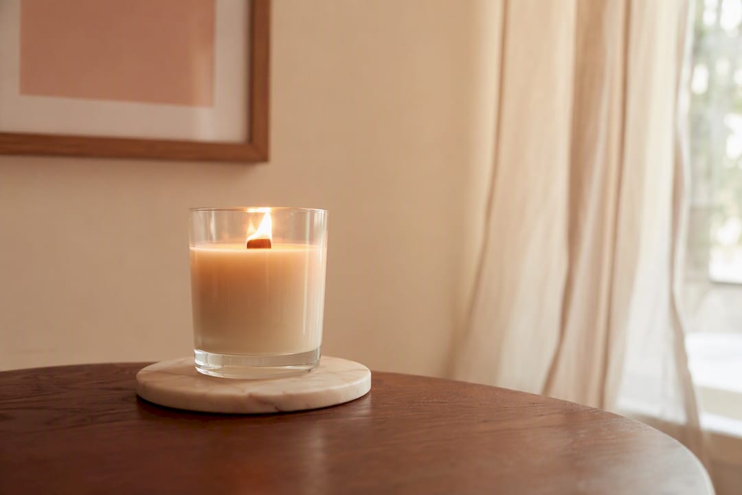 Wooden wick candle on heat-resistant surface safely
