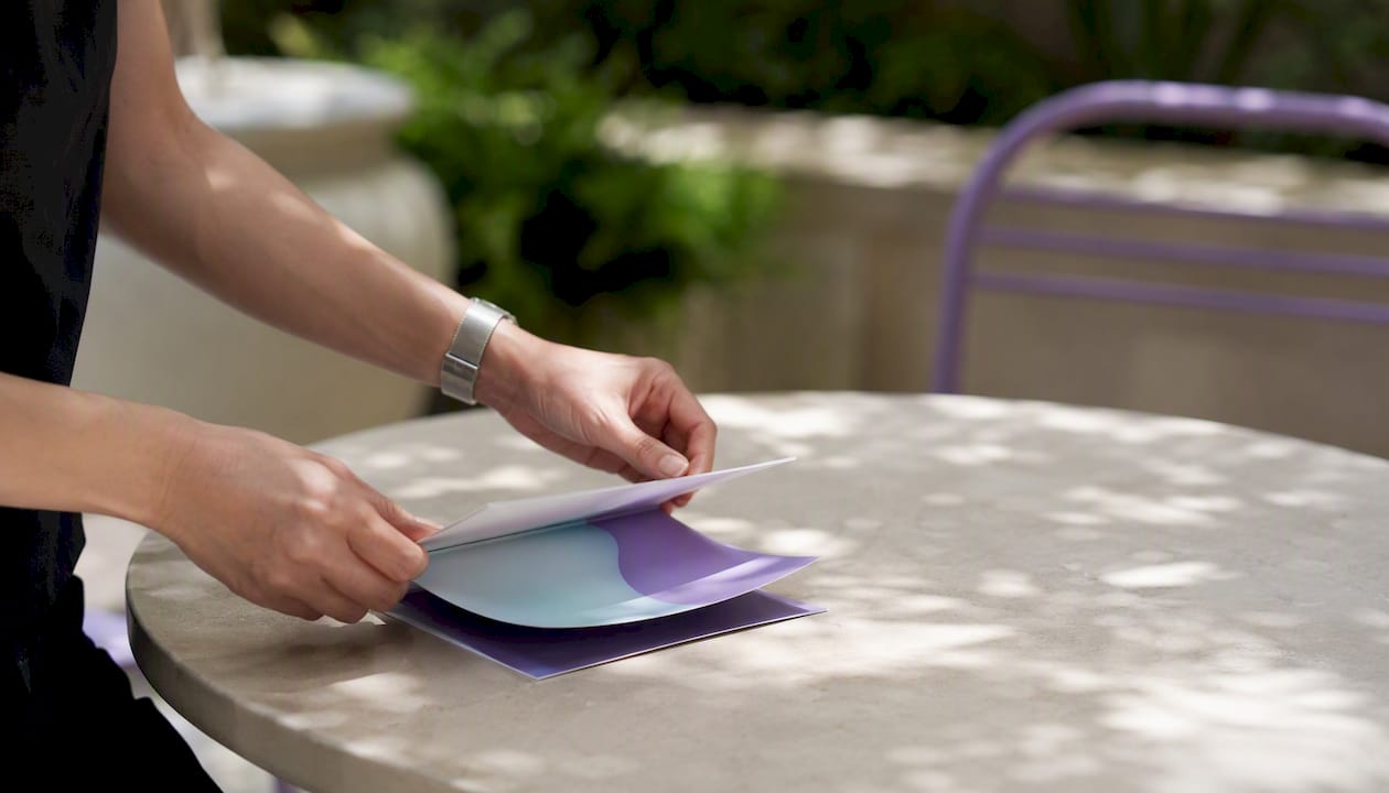 Hands expanding portfolio card interaction