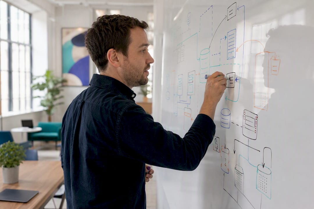 Hands designing backend architecture diagram