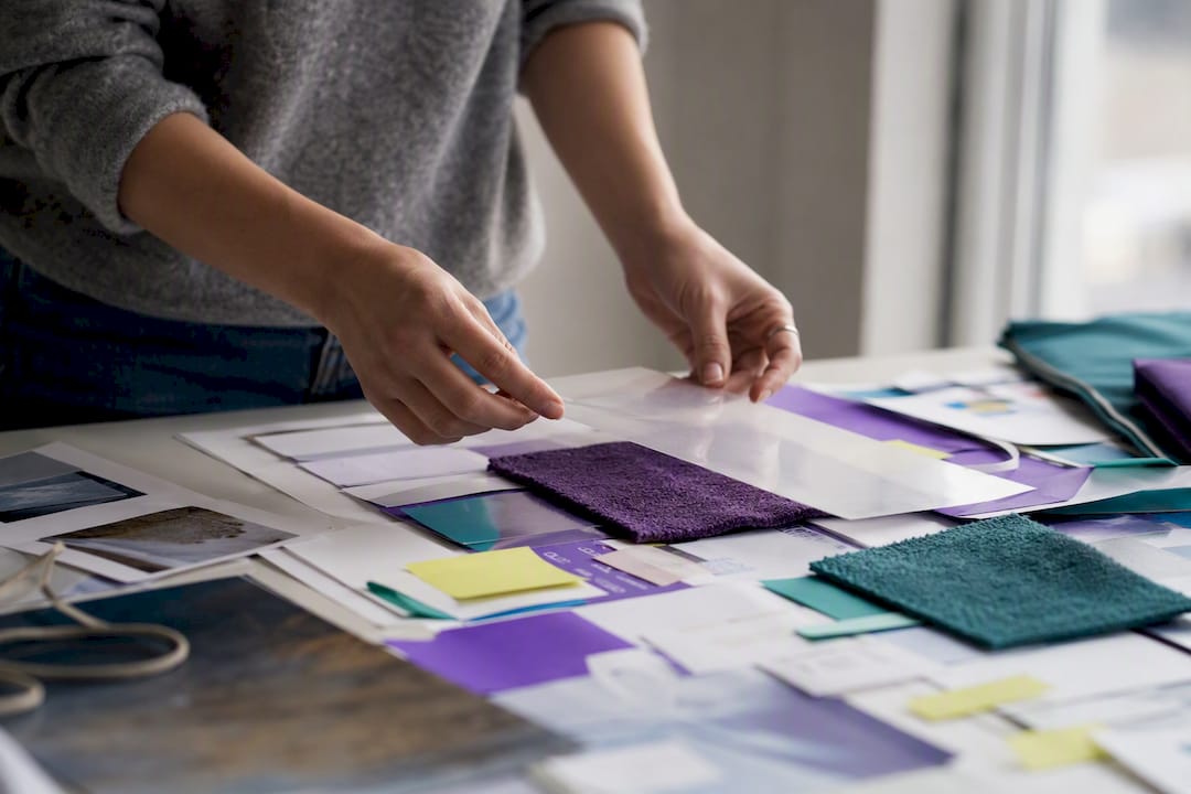 Designer placing acetate overlay on project board