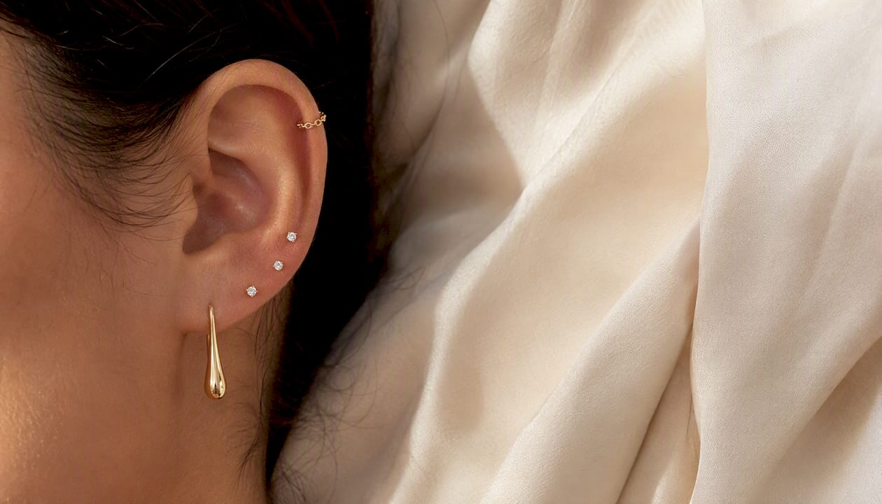 Curated ear stacking with statement hoop and studs