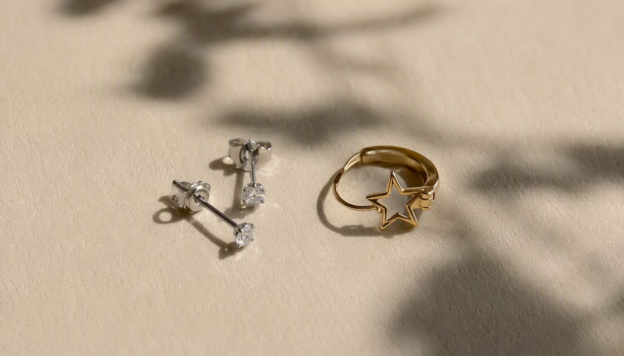 Diamond studs and celestial huggie earrings detail