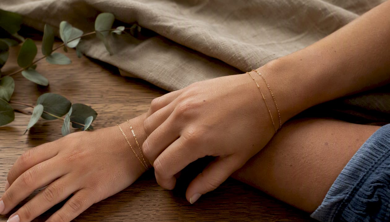 Stacked friendship bracelets on wrists