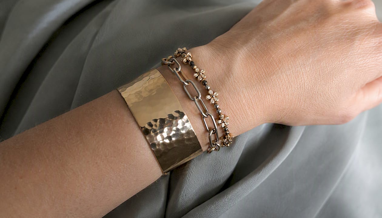 Close-up of mixed texture bracelets on wrist