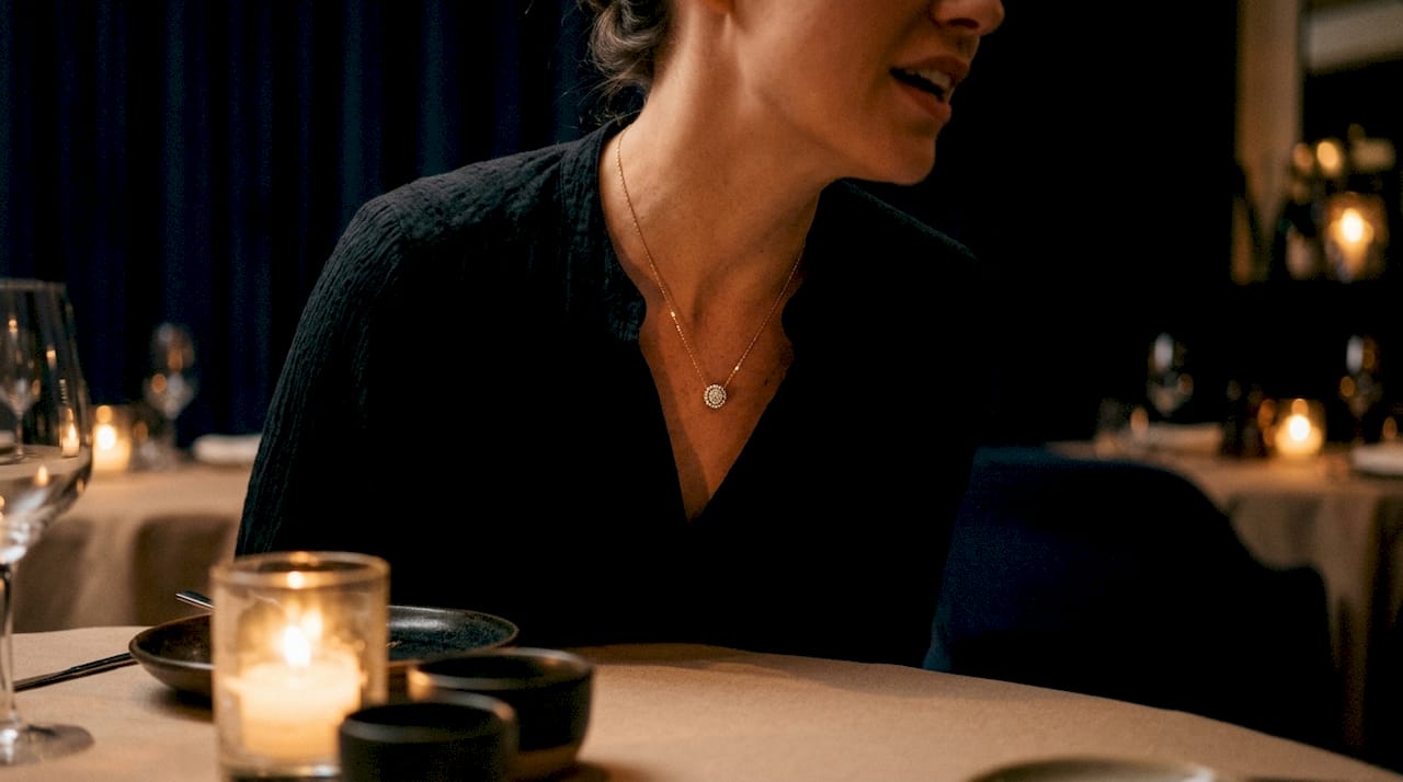 Diamond pendant sparkling in warm candlelight