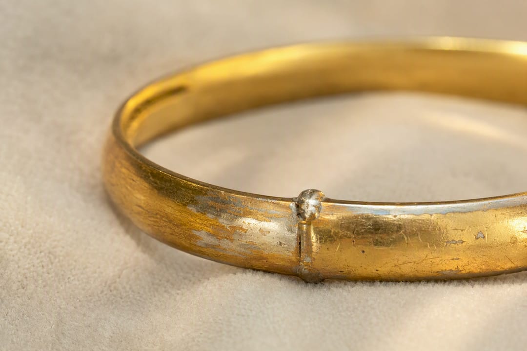 Primer plano del desgaste y los tonos en una pulsera dorada