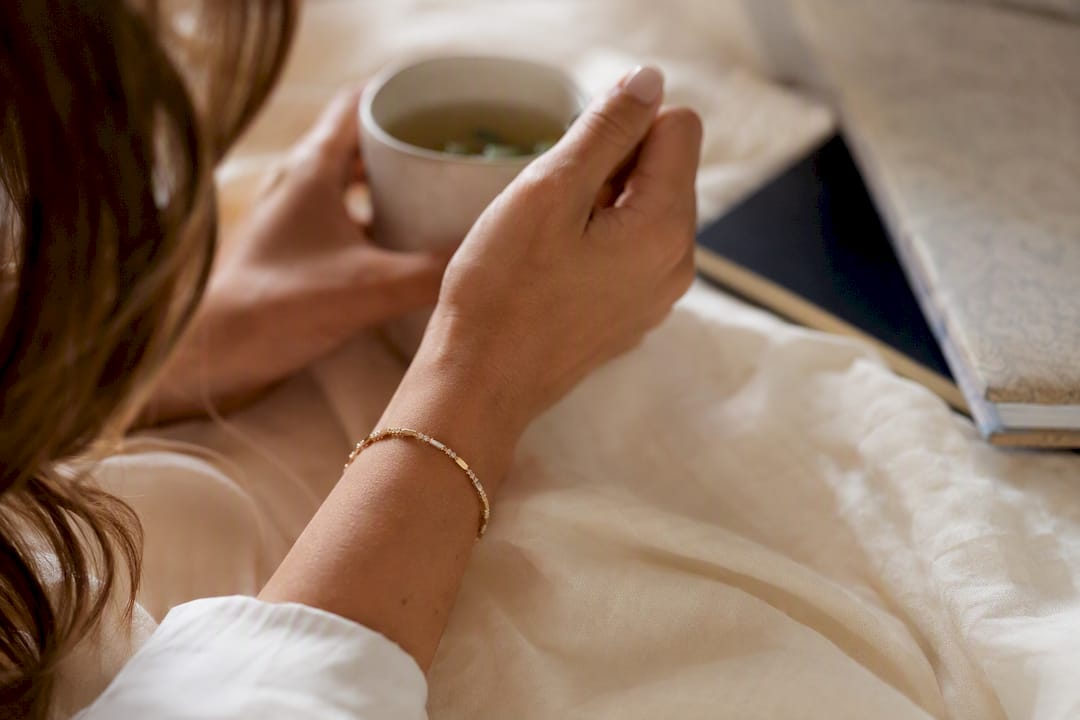 Elegant gold stacking bracelet on wrist