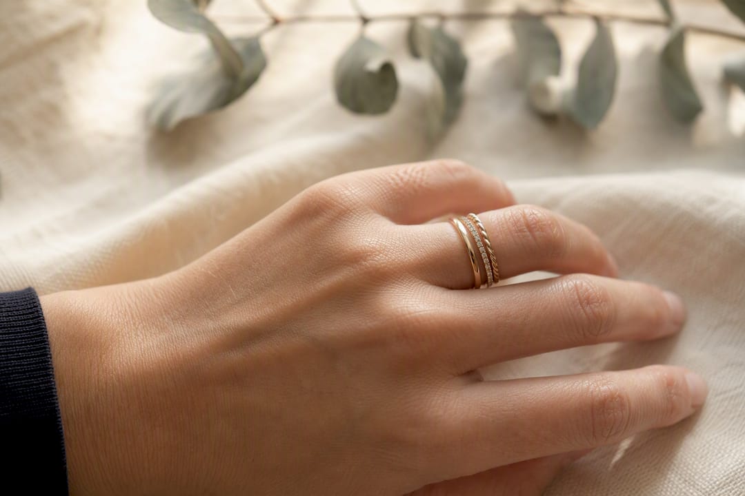Three minimalist rings stacked on finger