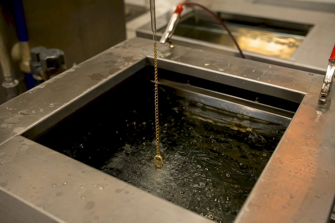 Detalle del proceso de electrochapado con baño de oro