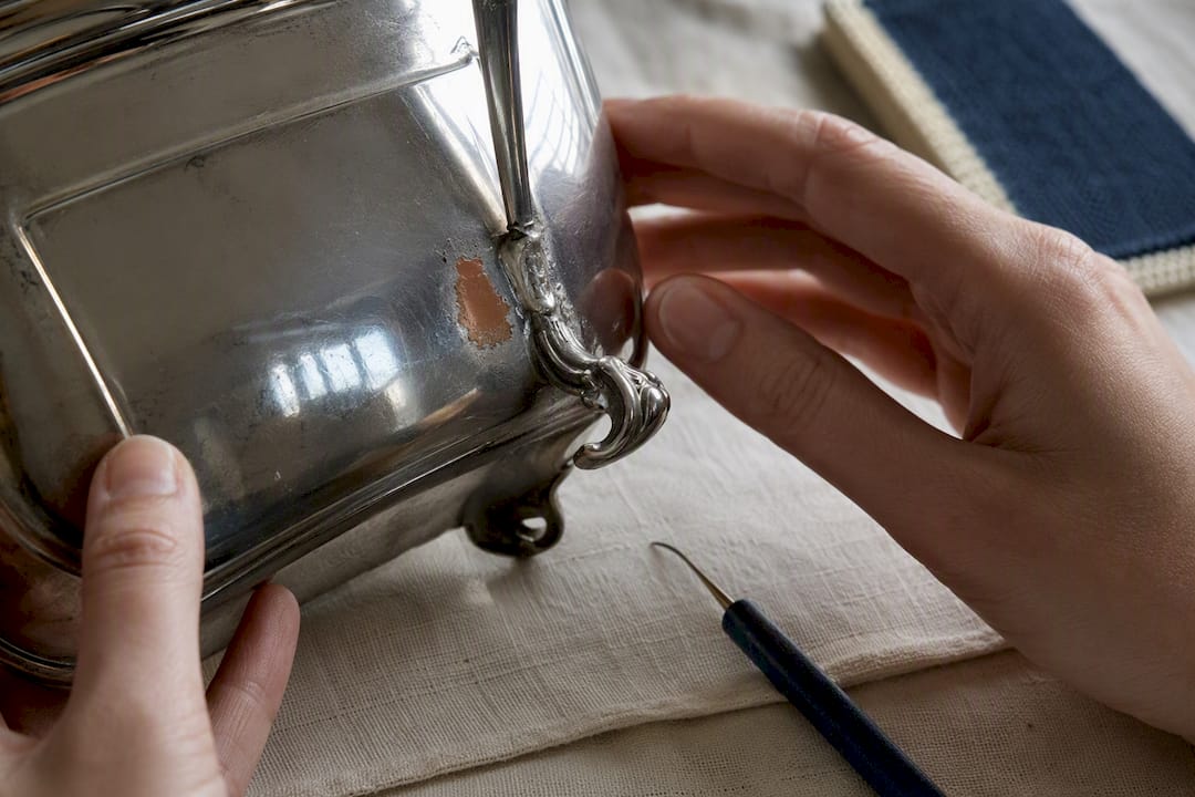 Worn silver plating beside a soldered repair