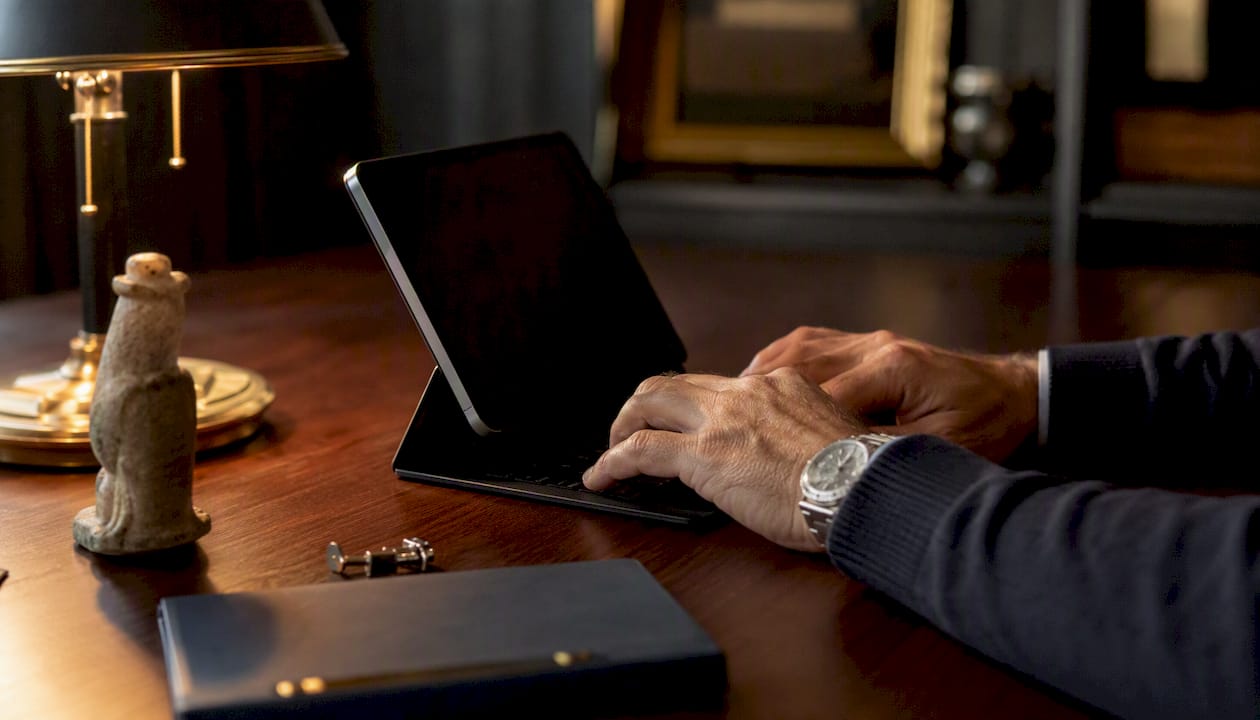 Hands typing on tablet for Notice of Death