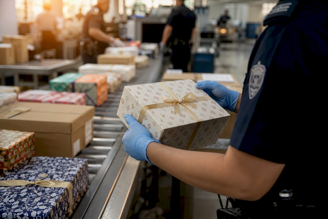 Customs officer inspecting wrapped gifts