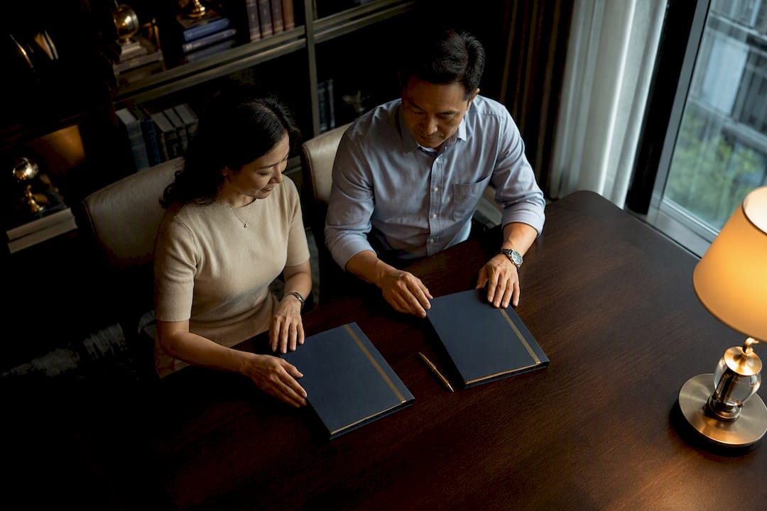 Two separate will folders on walnut table
